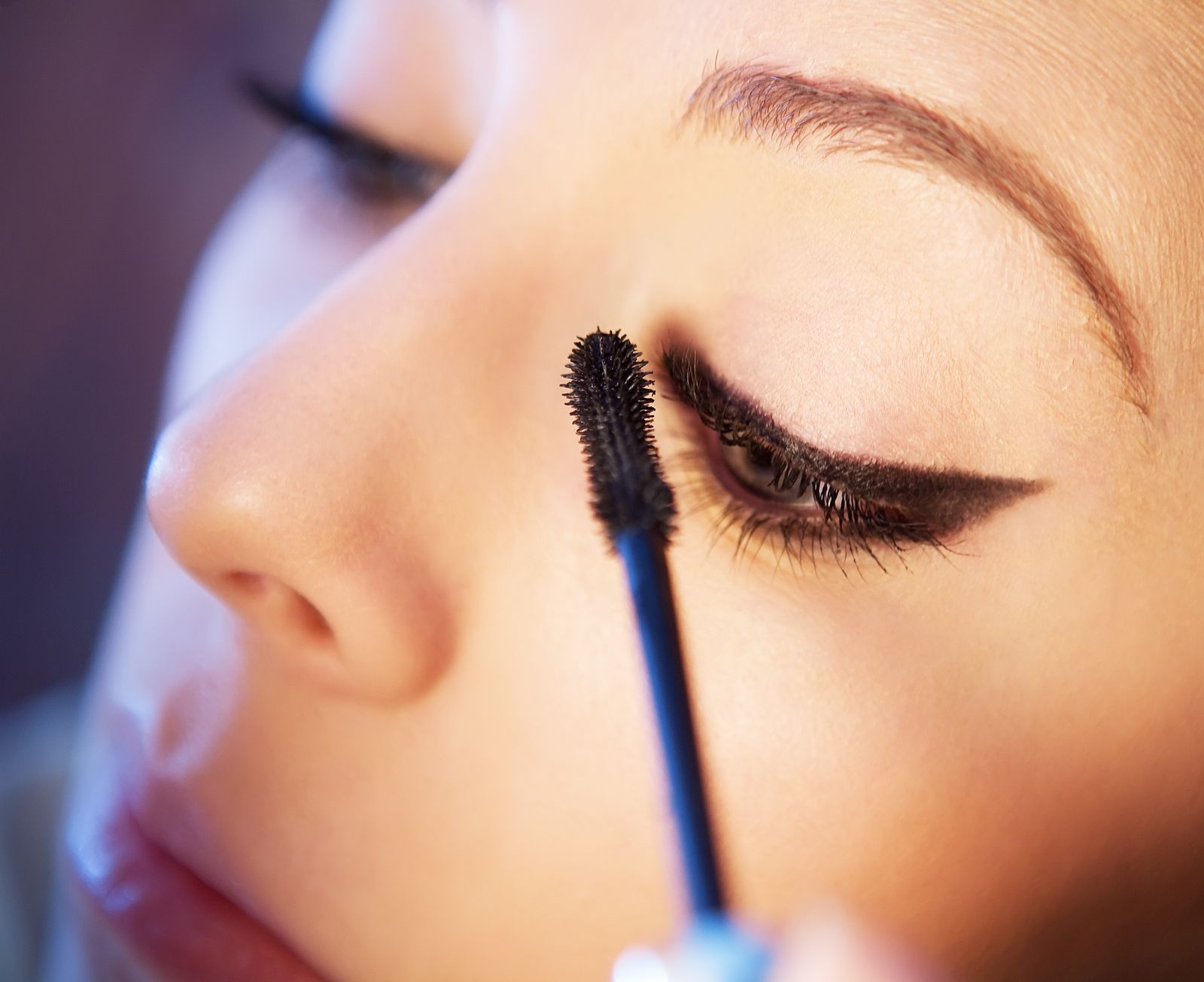 Close-up of a woman applying mascara