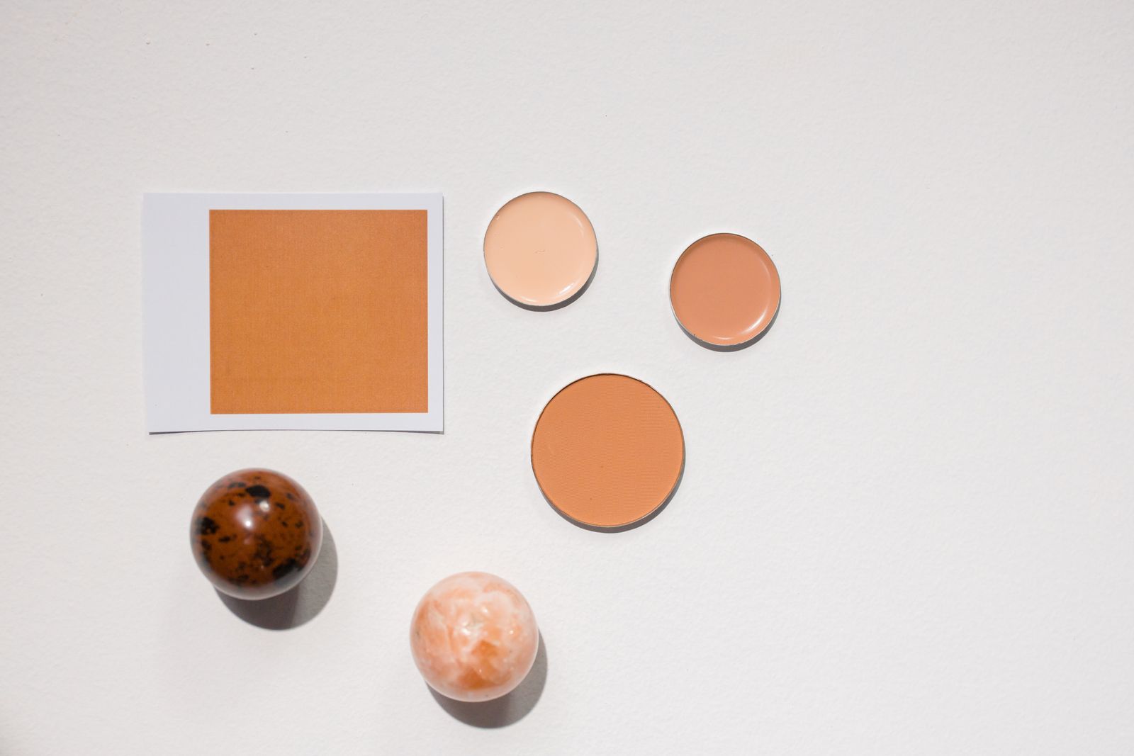A selection of cosmetics arranged on a white surface